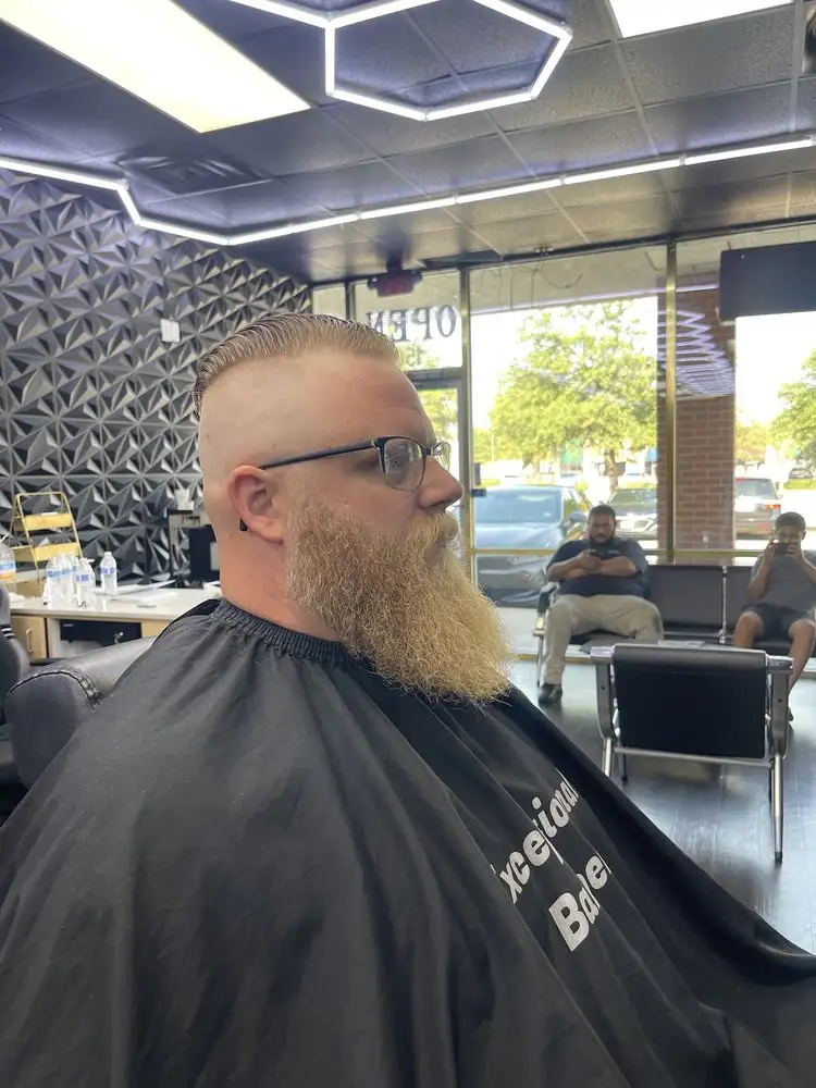 A long beard and buzzed sides, side view