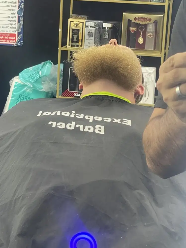 A client with a bleached, cropped cut in the chair