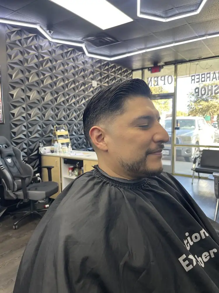 A swept-back cut and beard, side view