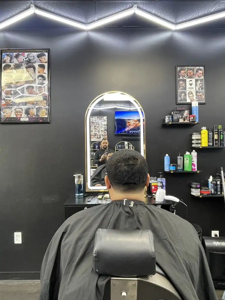 A client facing an arched mirror after a cut