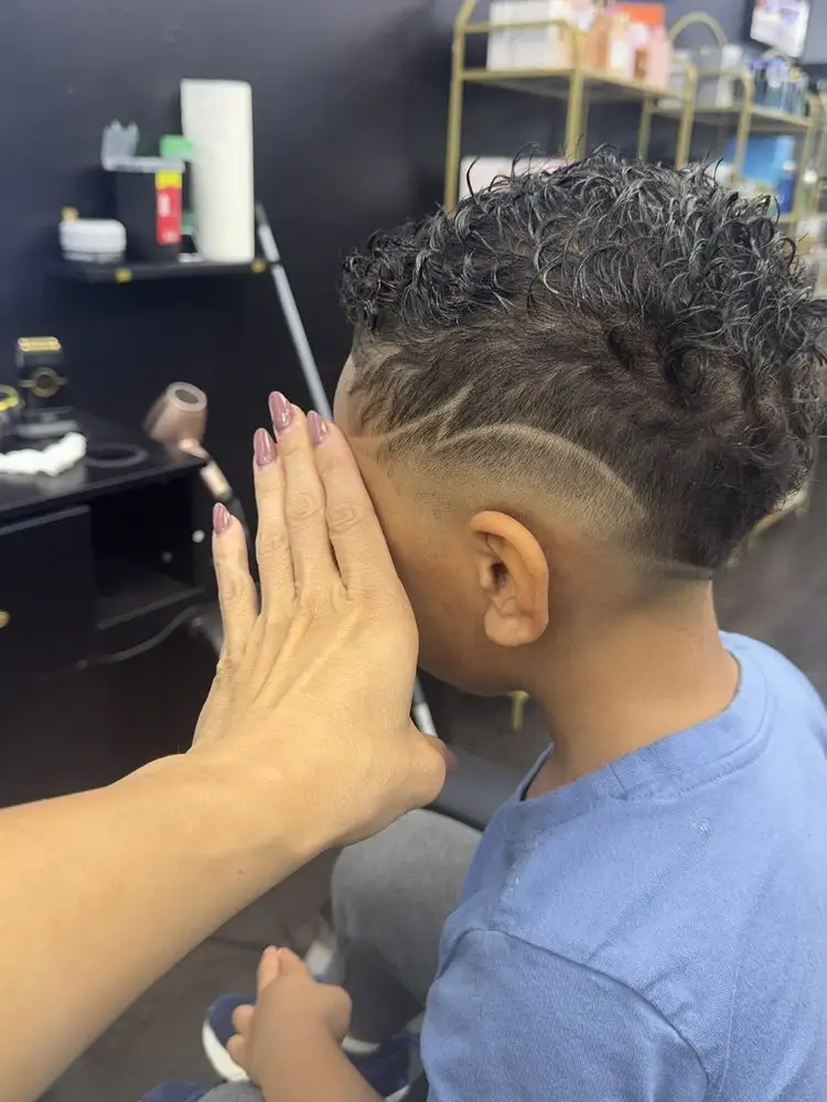 A child's haircut with a shaved line design